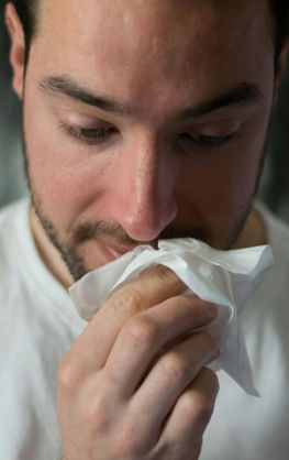 man wiping mouse with tissue paper